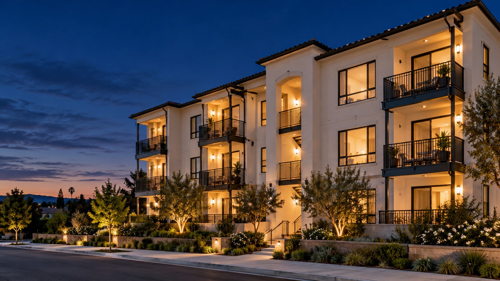 Apartment building with illuminated balconies at twilight